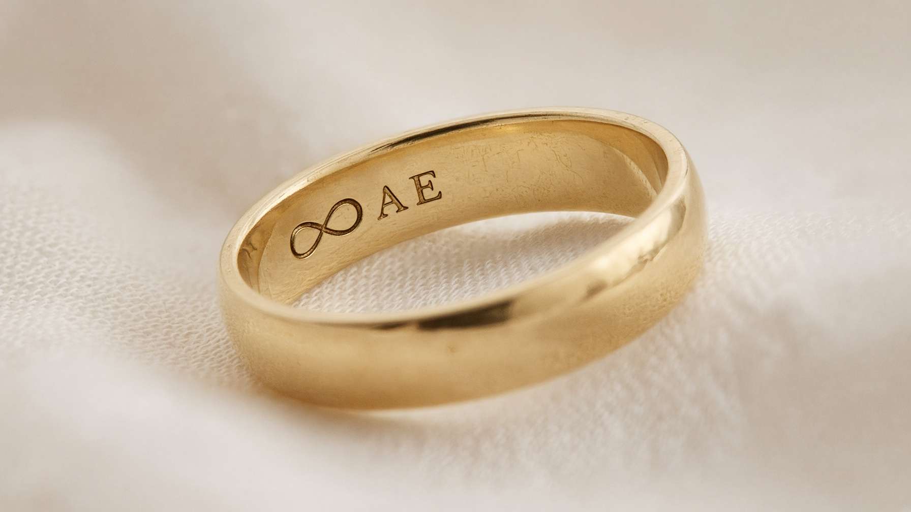 Wedding band engraved with a symbol and initials